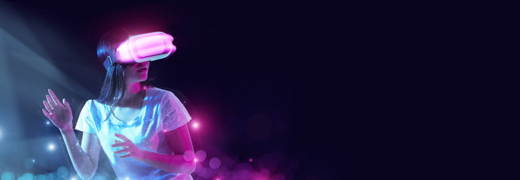 Excited young Asian lady using VR glasses - NFT News Today